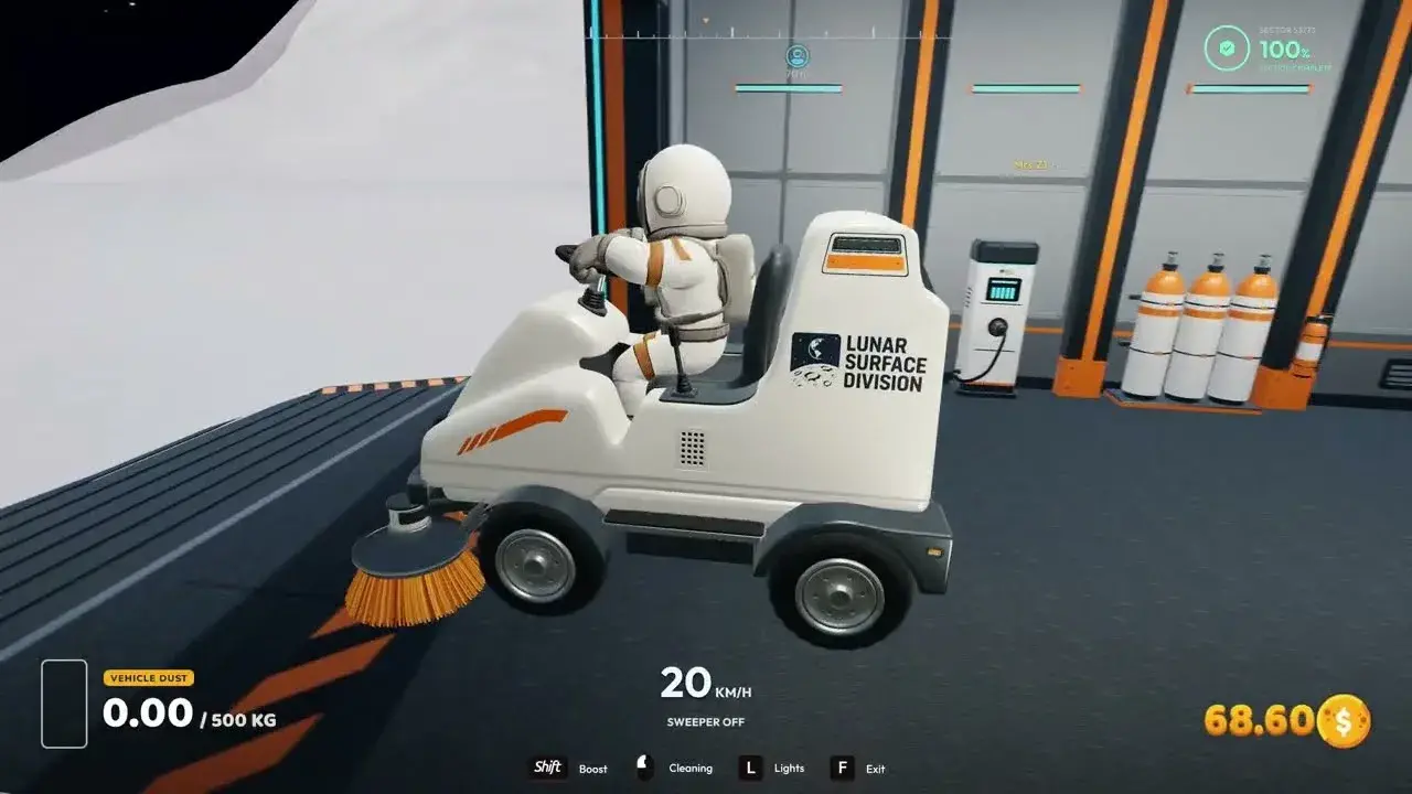 Astronaut on a ride-on sweeper inside a garage bay, with the vehicle dust gauge at 0 of 500 kg